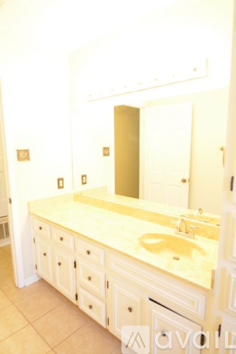 A bathroom with a sink and a mirror.