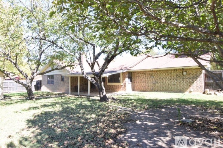A house with a tree in front of it.