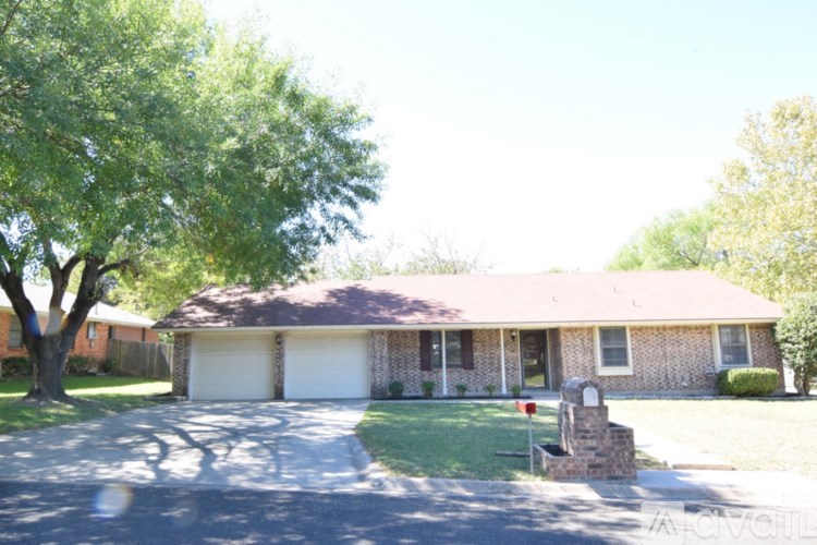 A house with a driveway and a mailbox.