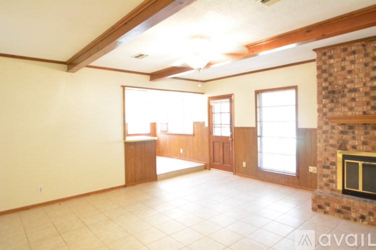 A living room with a fireplace and a tiled floor.
