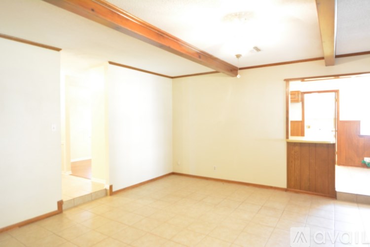 A room with a wooden cabinet and a window.