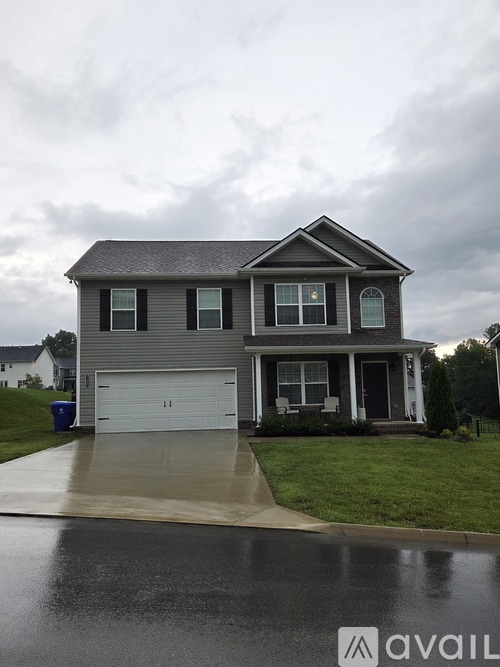 A two-story house with a white garage door.