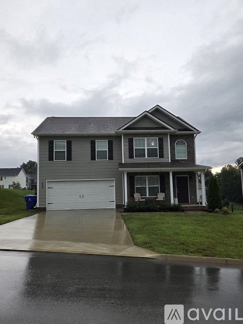 A two-story house with a white garage door.