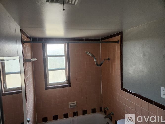 A bathroom with a shower, toilet, and sink.