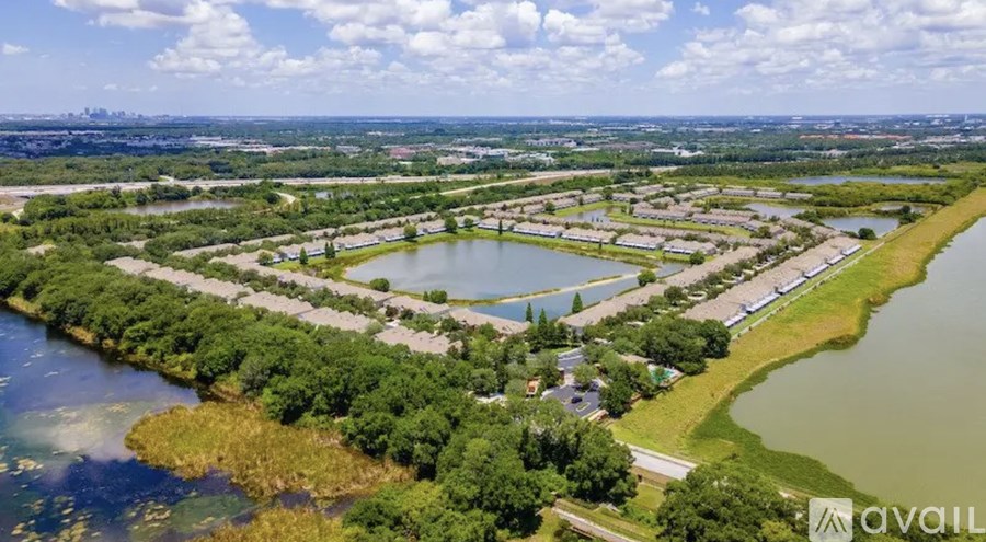 A bird's eye view of a residential area with a river running through it.