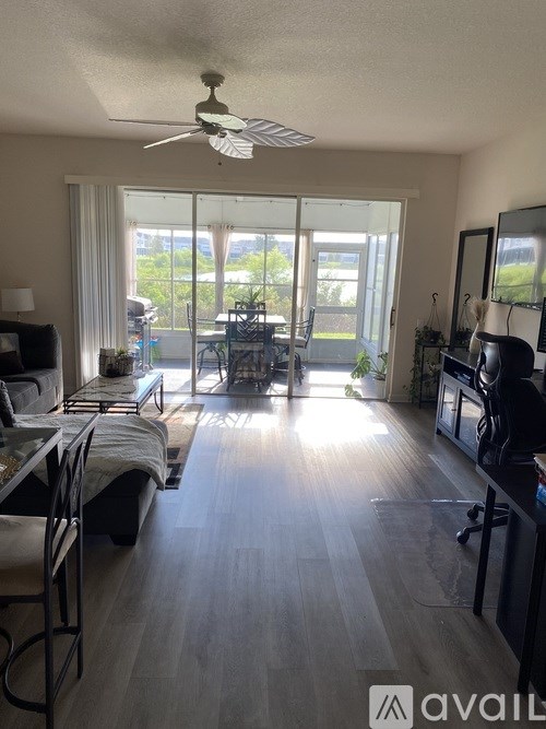 A living room with a sliding glass door leading to a patio.