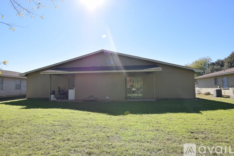 A house with a sunny sky in the background.