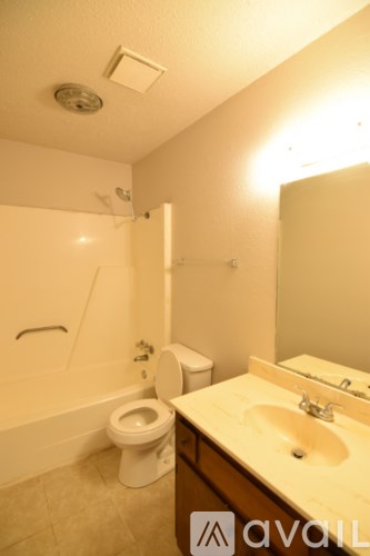 A bathroom with a toilet, sink, and shower.