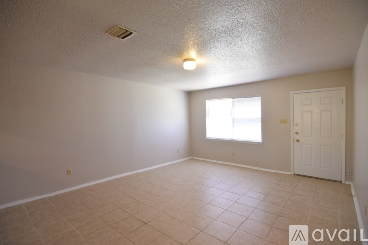 A room with a tiled floor and a window letting in natural light.