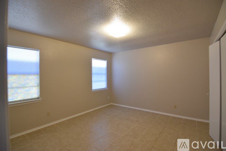 A room with a window and a door.