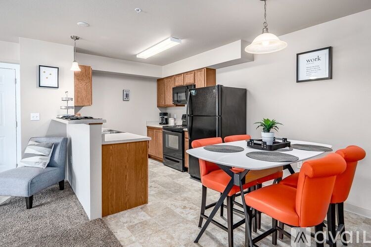 A kitchen with a table and chairs.