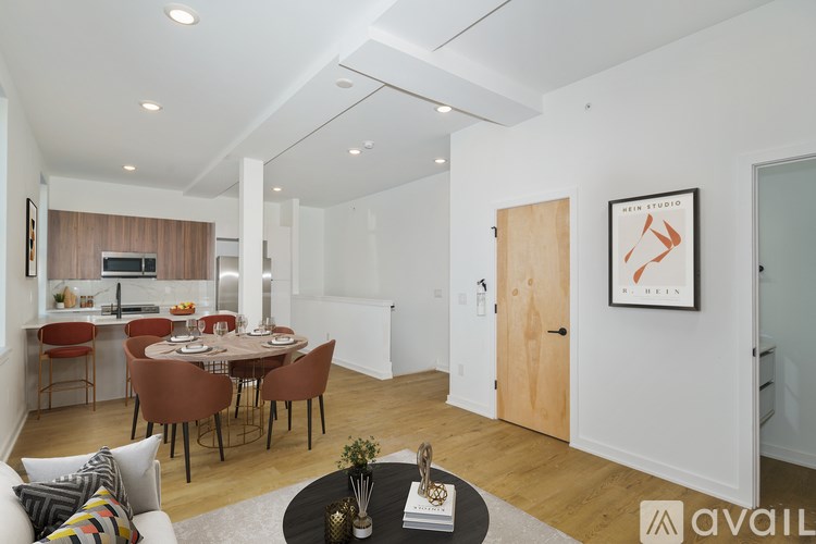 A modern living room with a dining table and chairs.