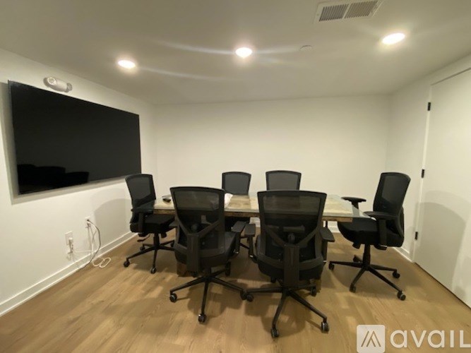 A conference room with a large table and chairs.