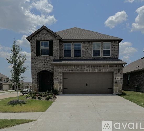 A house with a stone facade and a large garage door.