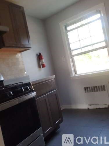 A kitchen with a stove and a window.