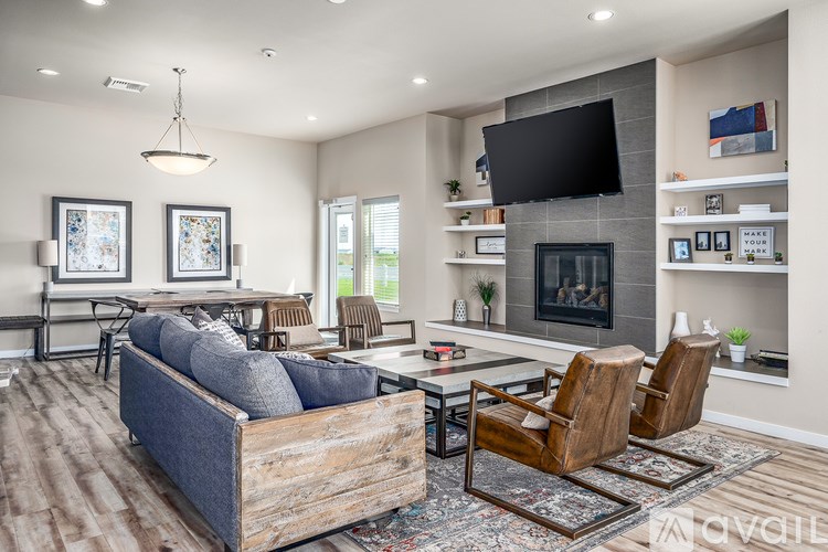 A modern living room with a grey sofa, a wooden coffee table, and a fireplace.