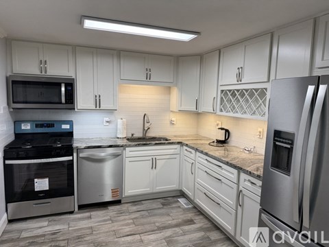 A kitchen with white cabinets and stainless steel appliances.