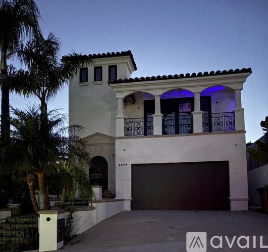 A house with a balcony and a garage is shown.