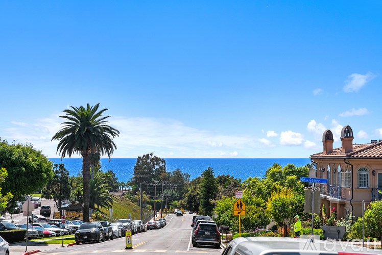A room with a ceiling fan and sliding glass doors.