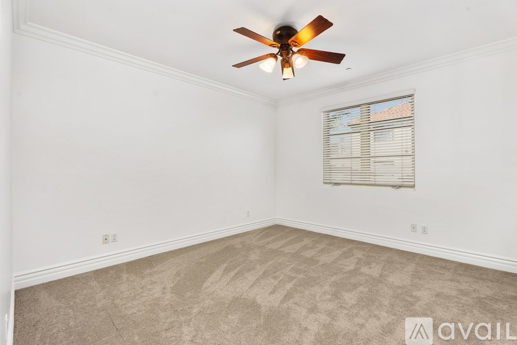A room with a large window and a balcony outside.