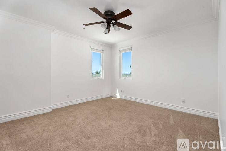 A bathroom with a glass shower stall and a white toilet.