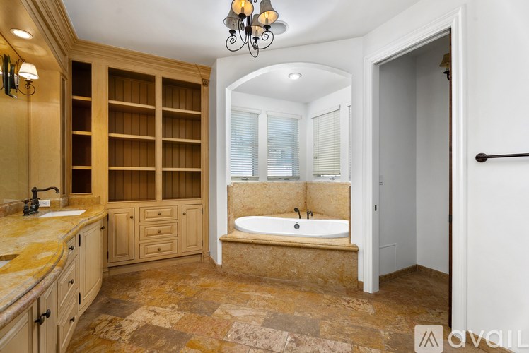 A balcony with a glass door, a lamp, and a trash can.