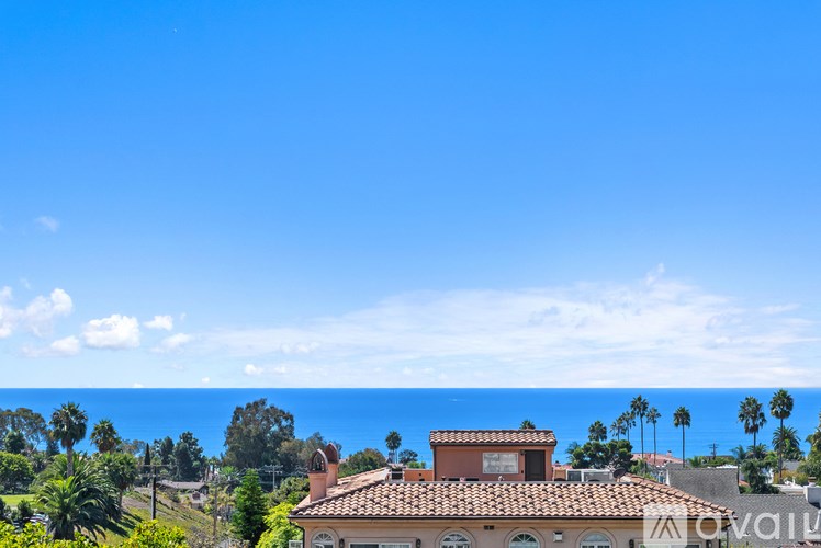A patio with a table and chairs is set up outside a home.
