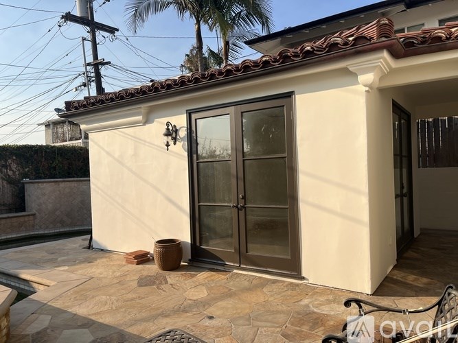 A house with a brown tiled roof and a glass door.