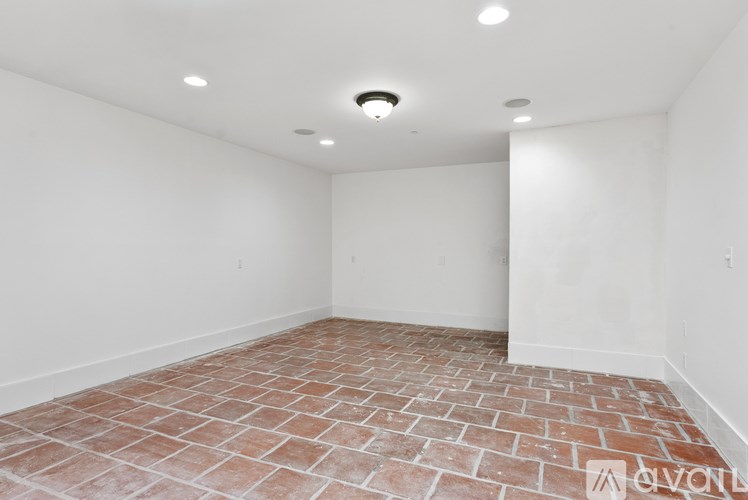 A room with a brick floor and white walls.