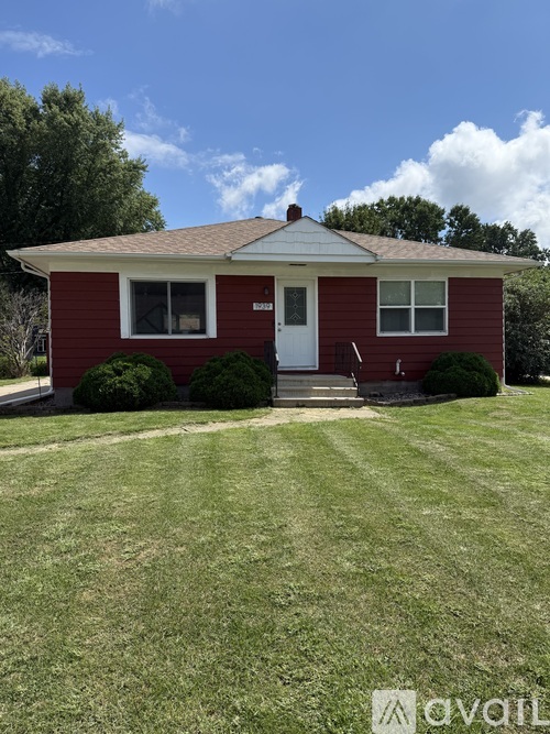 A red house with a white door and windows.