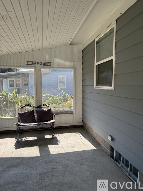 A patio with a bench and a sign that says "Welcome to PVYNK".