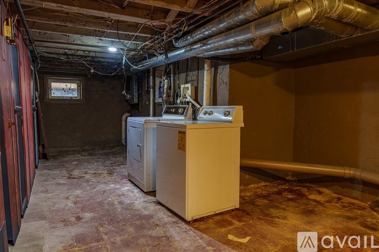 A room with a large industrial-sized heater and a pipe system.