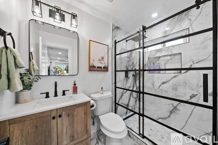 A bathroom with a marble wall and a toilet.