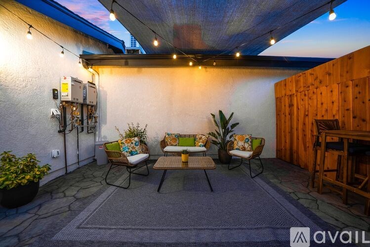 A patio with a table and chairs under a canopy.