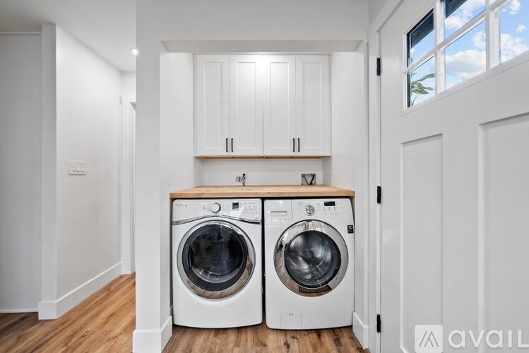 A washing machine and dryer in a laundry room.