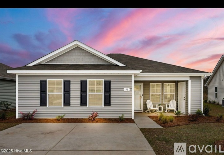 A house with a front porch and a driveway is shown.