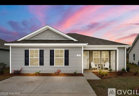 A house with a front porch and a driveway is shown.