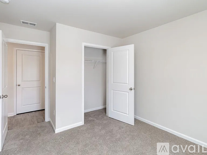 A room with two doors, one of which is open.
