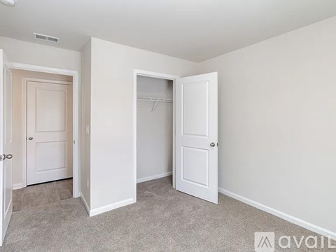 A room with two doors, one of which is open.