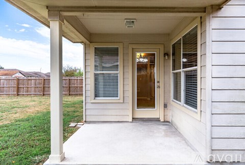 A house with a white porch and a brown door.