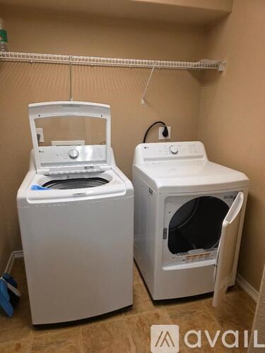 A white washing machine and dryer in a small room.