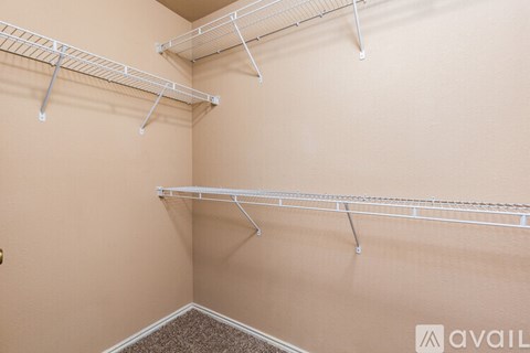 Empty shelves in a room with beige walls.