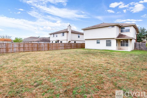 A house with a fence in front of it is for sale.