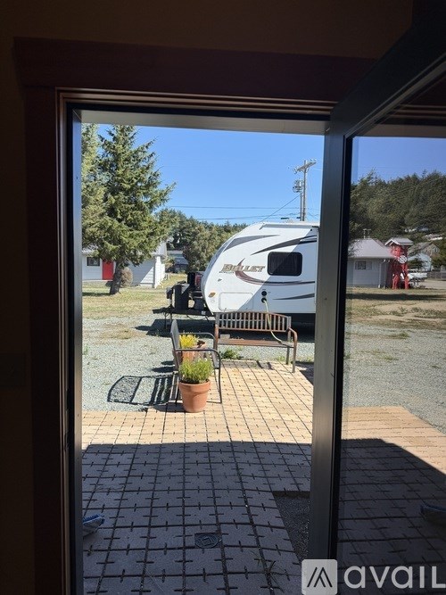 A patio with a table and chairs is visible through a glass door.