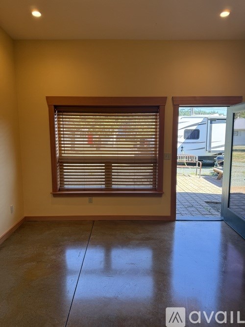 A room with a window and a tiled floor.