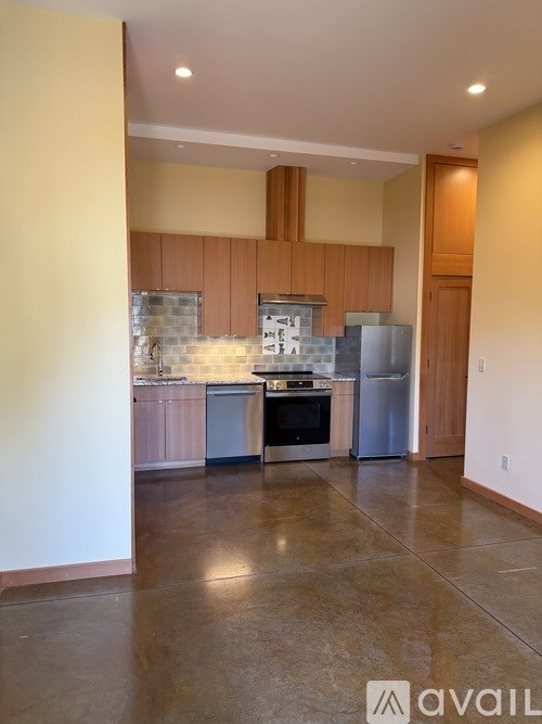 A kitchen with wooden cabinets and a tiled backsplash.