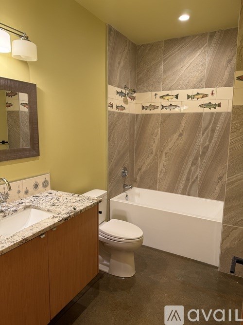 A bathroom with a toilet, sink, and bathtub.