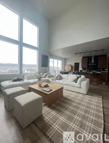 A living room with a large window overlooking a cityscape.