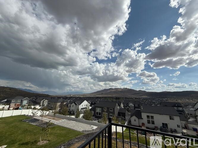 A view of a residential area with houses and a cloudy sky.
