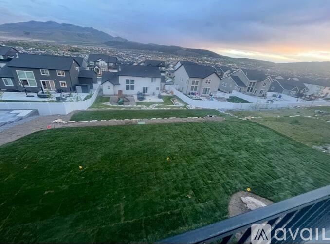 A bird's eye view of a residential area with houses and green lawns.